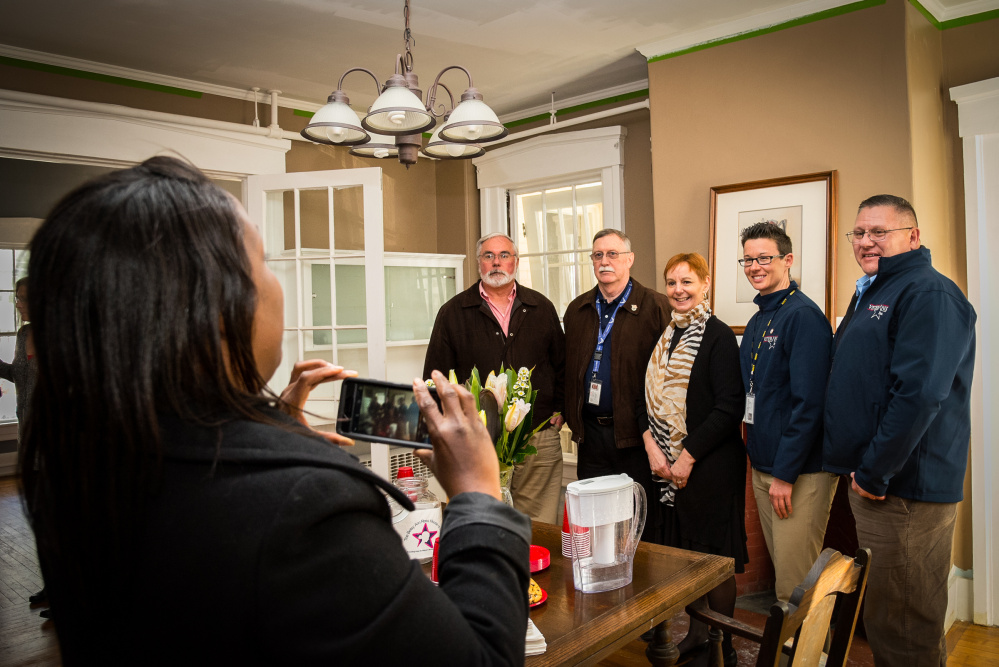 Andrea Tolbert, left, of the Portland Veterans Center, takes a photo Thursday at an open house at the Betsy Ann Ross House of Hope in Augusta. From left aree Larry Duquette, of the VA Maine Healthcare Systems-Togus; Michael Tilton, of Veterans, Inc., in Lewiston; Martha St. Pierre, Betsy Ann Ross House founder; and Alley Smith and Leo Deon, of Veterans, Inc.