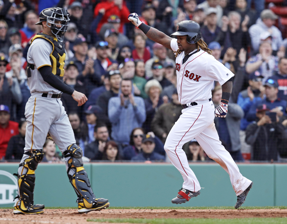 Boston's Hanley Ramirez, right, pumps his fist as he passes Pittsburgh catcher Chris Stewart, left, while scoring on an RBI single by Xander Bogaerts during the eighth inning Thursday in Boston.