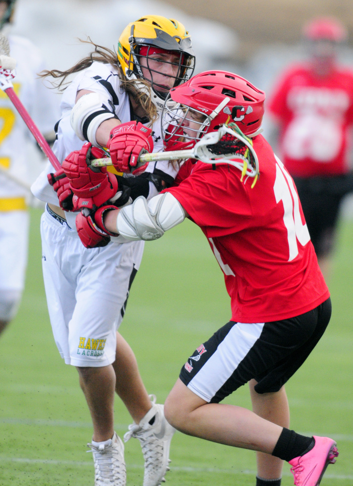 Maranacook/Winthrop's Jack Vickerson, left, takes a shot around the defense of Cony's Micquiez Baisuz on Thursday in Kents Hill.