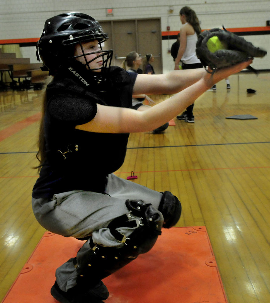 Skowhegan Area High School catcher Julia Steeves works out pitchers during an indoor practice session earlier this spring. Steeves joins Sydney Reed as a strong catching duo for the Indians.