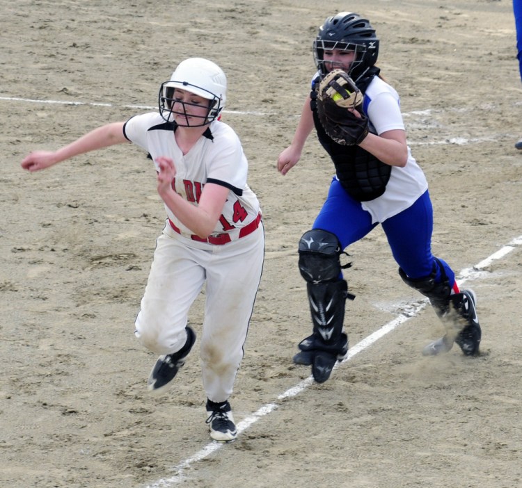 Hall-Dale baserunner Kayla Johnson tries to get back to third but can't outrun Oak Hill catcher Emma Hlister during a Mountain Valley Conference game last season. Hlister is one of the area's best catchers, and she's put in the offseason work to get to that point.