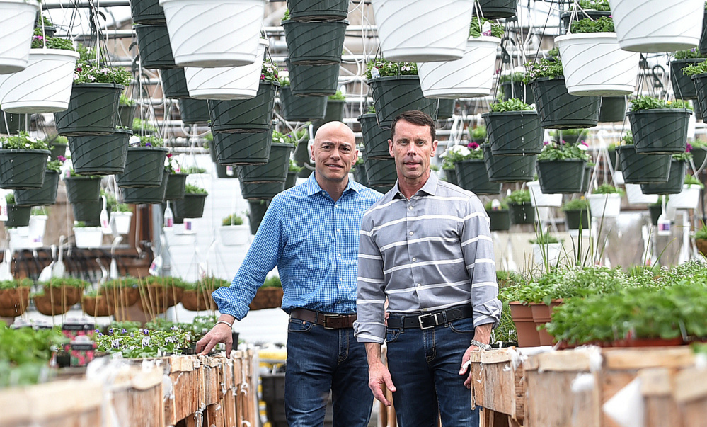 Michael Roy, left, and Brent Burger, of Campbell's True Value, pose for a portrait in one of the greenhouses at Campbell's Agway True Value hardware store in Winslow.
