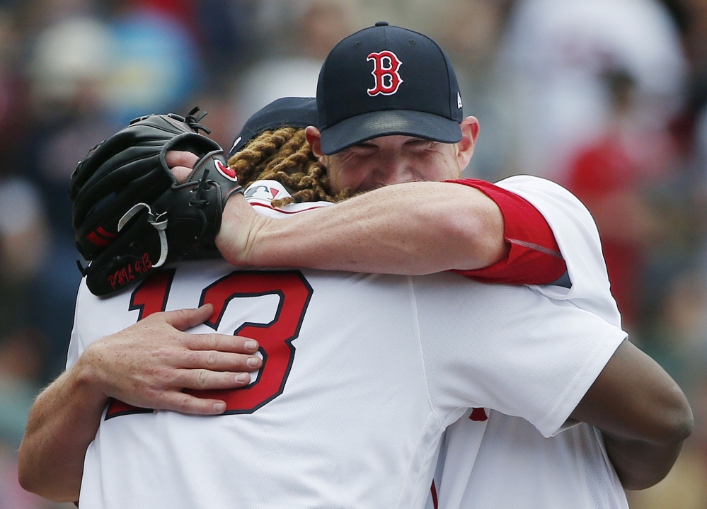 Boston Red Sox slugger Hanley Ramirez (13) hugs Craig Kimbrel after the Red Sox defeated the Rays 4-3 Monday.