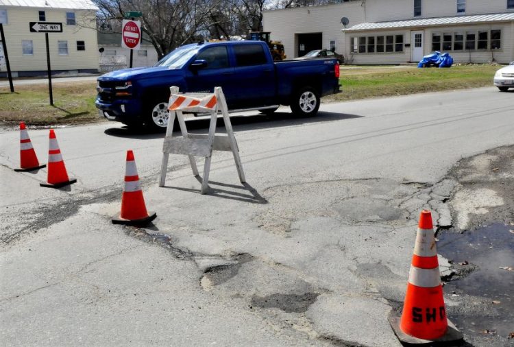Traffic passes one way on Gem Street in Skowhegan on Monday past cones set up to alert drivers the roadway is no longer a two-way road.