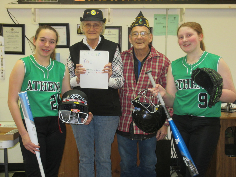 Captains of the Athens Community School softball team, wearing new uniforms and holding new equipment bought with donations from American Legion Post 192 and its Ladies Auxiliary, present the organizations' presidents a thank-you card. From left are Captain Kira Braley, presidents Robert Doiron and Linda Doiron, and Captain Kaitlyn Pomelow.