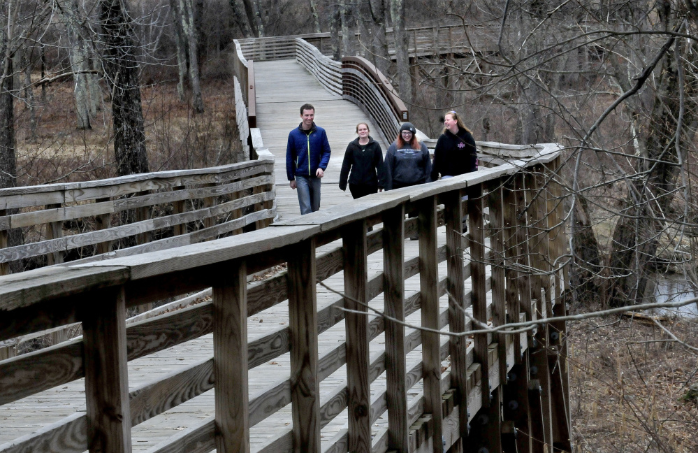 A group of Unity College students pass over the Community Bridge on Tuesday on the Hills-to-Sea Trail near the beginning of the 47-mile trail from Unity to Belfast. From left are Gunnar Norback, Rae-Ann MacLellan-Hurd, Catherine Bilodeau and Samantha Marley.