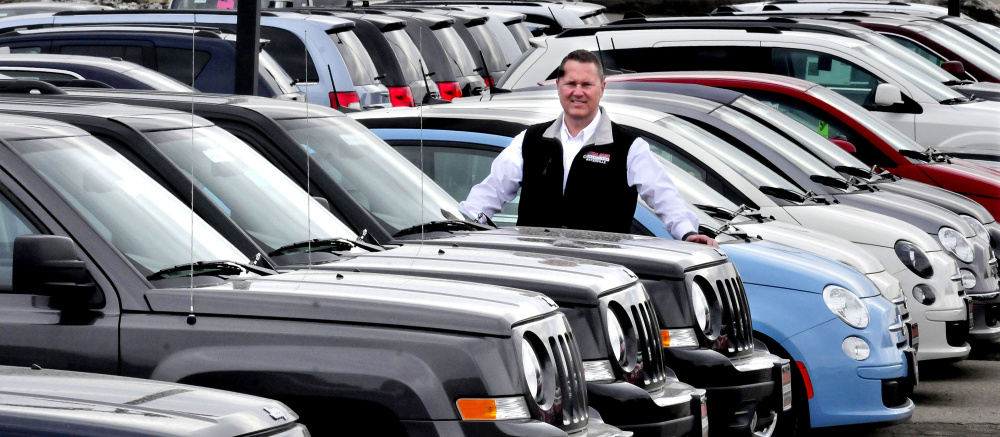 Chris Gaunce stands amid new cars April 12 at his family's Central Maine Auto Group dealership in Waterville. Gaunce has been selected as the Mid-Maine Chamber of Commerce's 2016 Business Person of the Year.