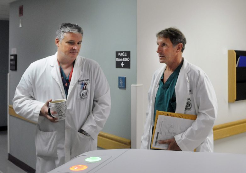 Dr. William Curtis, left, and Dr. Cameron McKee speak July 11, 2016, on the surgical floor of VA Maine Healthcare Systems-Togus during a tour of the veterans hospital, which has made significant improvements in mental health care, according to a new federal report.