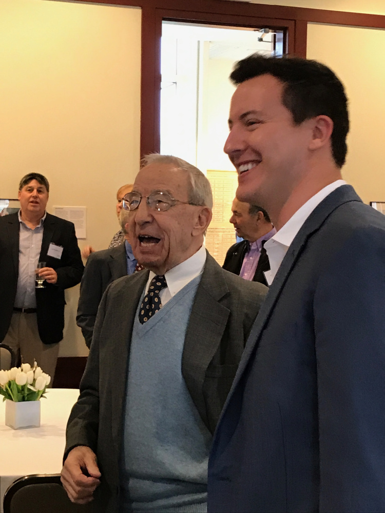 John "Swisher" Mitchell, left, enjoys a laugh with Colby College alum Mac Simpson on Saturday in Waterville. Colby celebrated Mitchell's 90th birthday by endowing the men's basketball assistant coaching position in Mitchell's name.