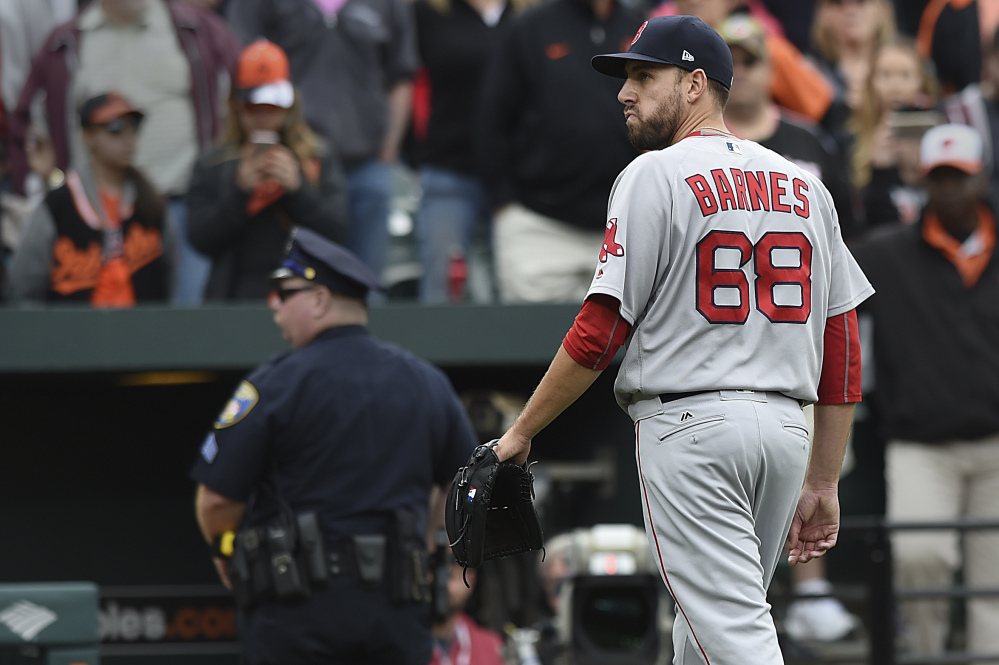 Boston Red Sox pitcher Matt Barnes walks off the field after being ejected for throwing at Manny Machado during the eighth inning Sunday in Baltimore. The Red Sox won 6-2.