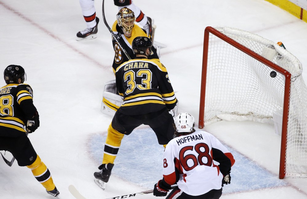 Boston goalie Tuukka Rask, top, and Zdeno Chara (33) watch the shot by Ottawa's Clarke MacArthur, not shown, enter the net during overtime in Game 6 of a first-round Stanley Cup playoff series Sunday in Boston.