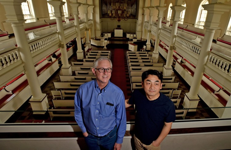 Jonathan Hailstrom, left, music professor and former conductor at Colby College, stands on Tuesday with Jinwook Park, right, current Colby College Symphony Orchestra conductor at Lorimer Chapel at Colby College in Waterville. Hailstrom said the orchestra's finale has been planned for weeks to honor Peter Ré. Park will conduct the concerts' selections.