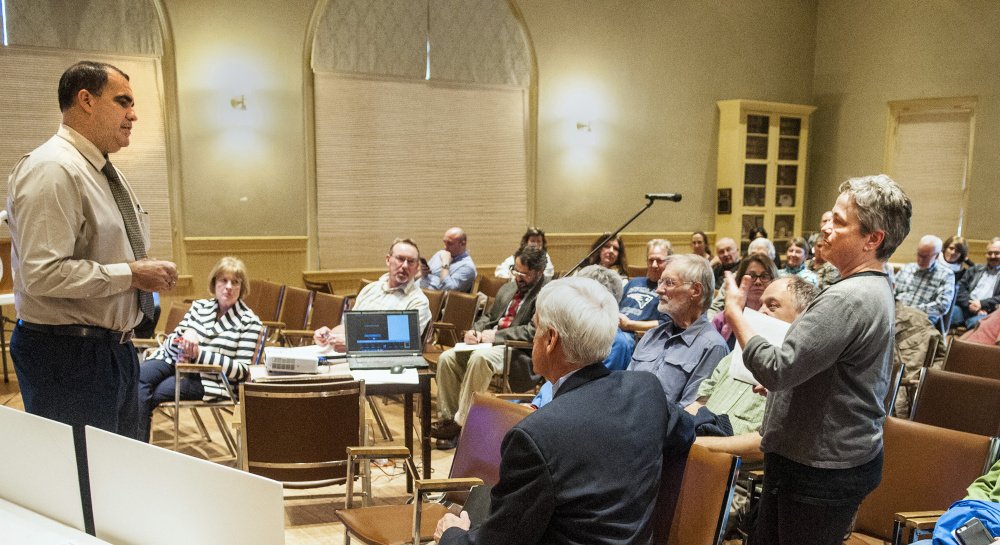 Maine Department of Transportation project manager Ernie Martin, left, answers a question Thursday from Deb Fahey, right, during a meeting about pending Water Street construction between DOT officials and residents in Hallowell City Hall.