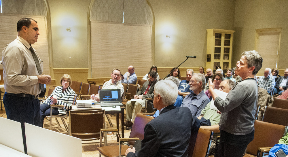 Maine Department of Transportation project manager Ernie Martin, left, answers a question Thursday from Deb Fahey, right, during a meeting about pending Water Street construction between DOT officials and residents in Hallowell City Hall.