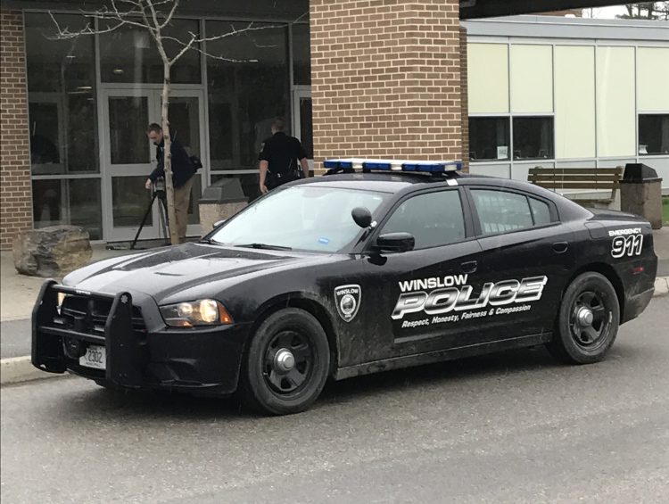 A Winslow police cruiser is parked outside Winslow High School on Friday morning after area schools went into lockout mode while authorities searched for a burglary suspect in the area.