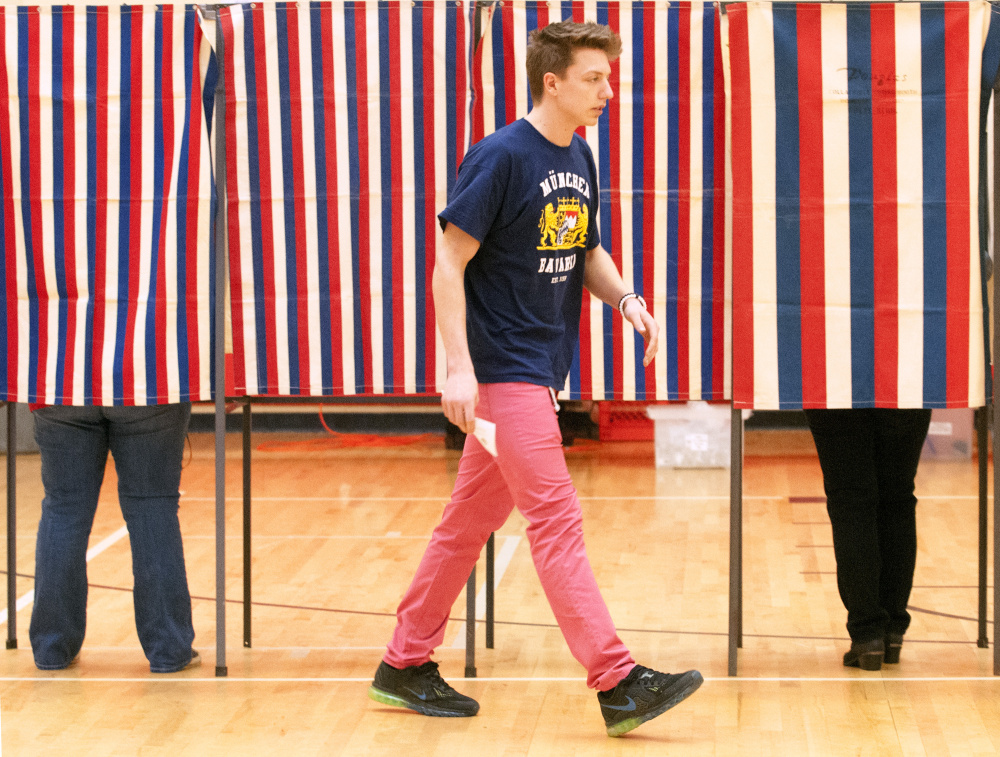 First-time voter Jett Boyer, who recently turned 18, walks toward a ballot box around 8:10 a.m. Friday in the Hall-Dale Elementary School gymnasium in Hallowell. Boyer, a Hall-Dale High School student, was missing part of government class to get registered and vote.