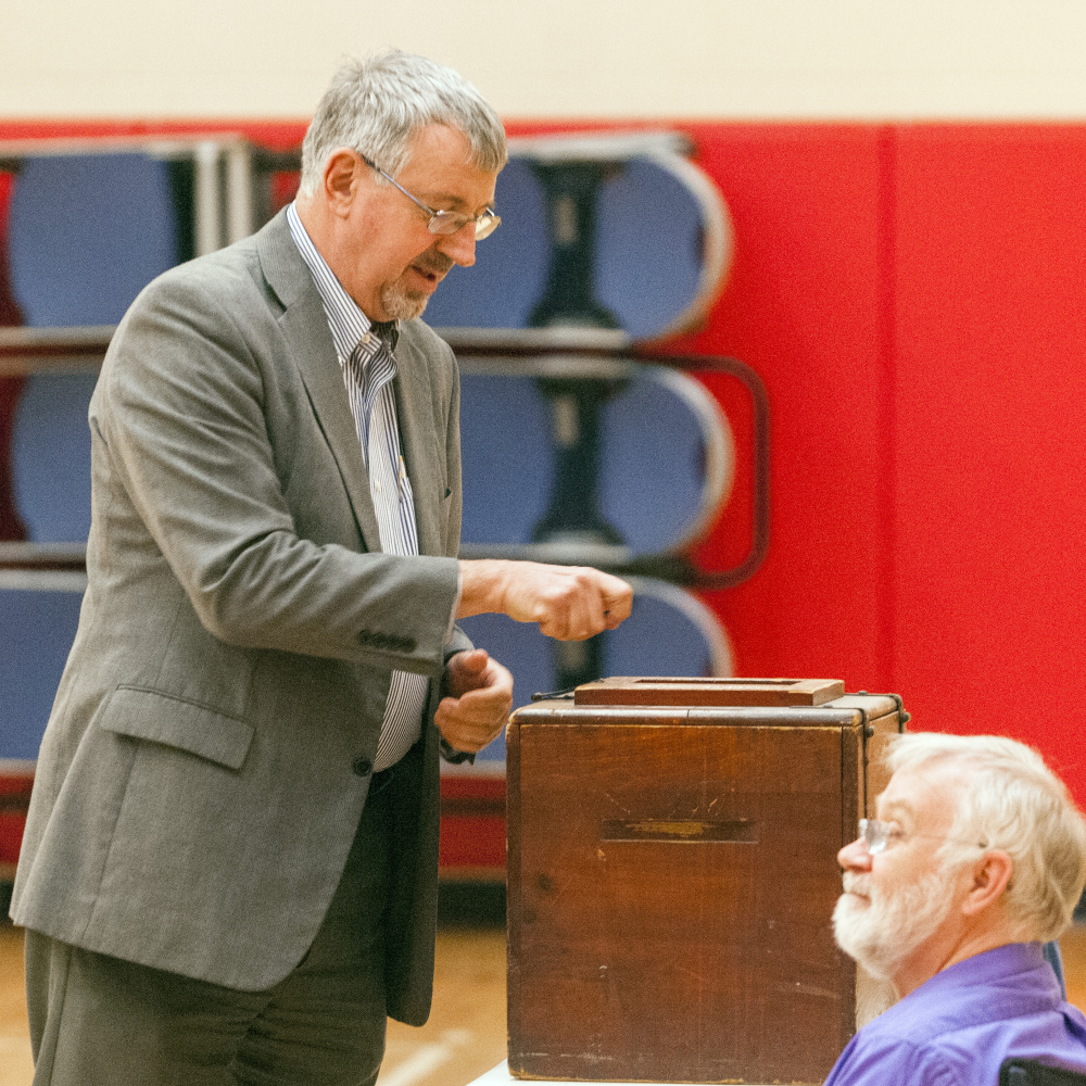 Staff photo by Joe Phelan
Mayor Mark Walker casts a bond vote ballot around 8:10 a.m. Friday in the Hall-Dale Elementary School gymnasium in Hallowell.