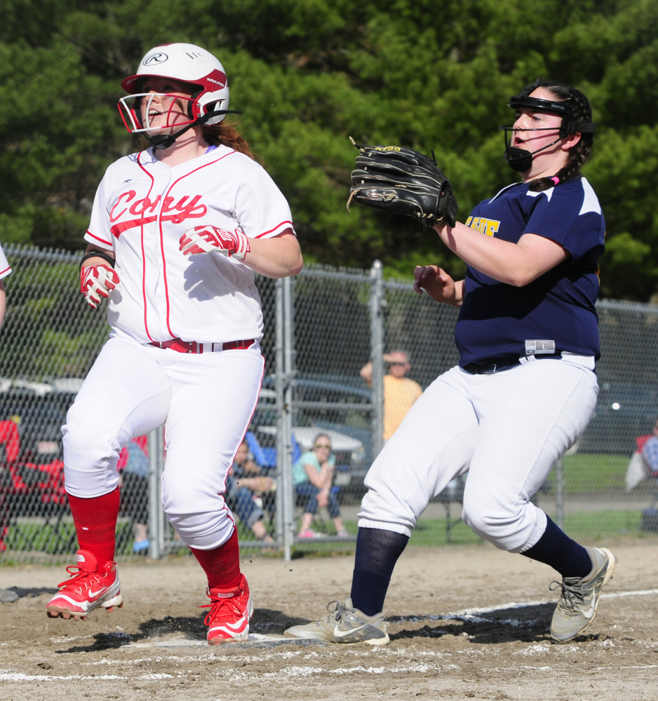 Cony's Cari Hopkins, left, scores on a wild pitch ahead of Mt. Blue pitcher Ellie DeCarolis, who was running in to cover home plate, Friday at Newman Brann Memorial Field in Augusta.