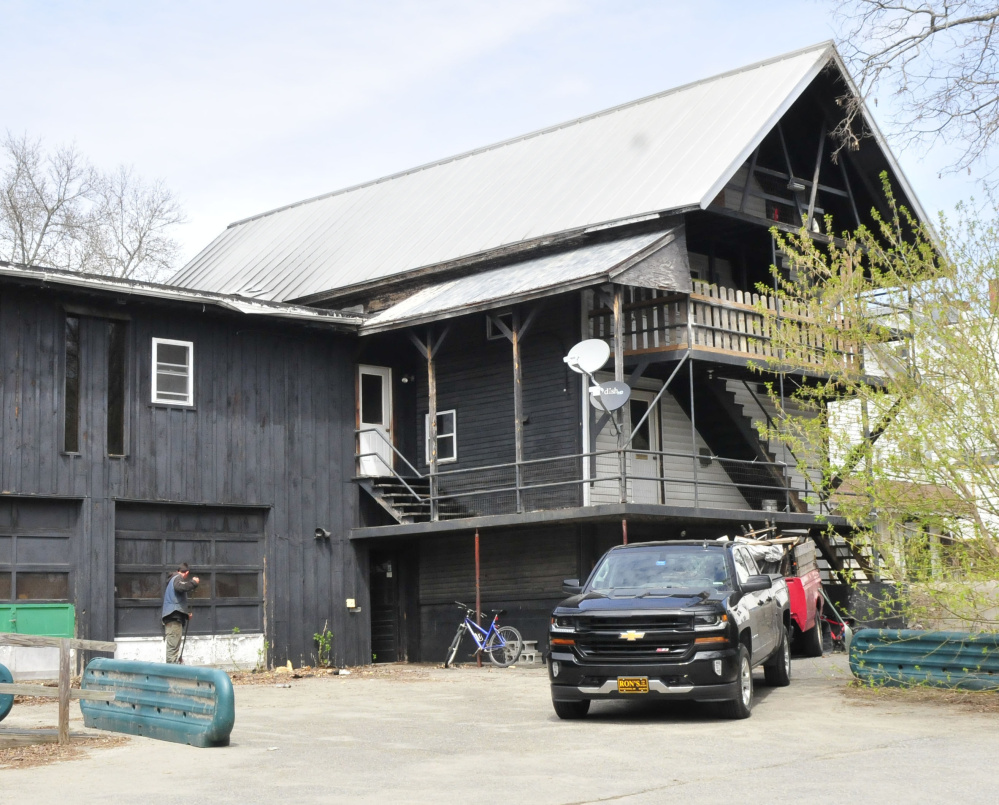 Workers clean up debris from College Avenue, Waterville, fire