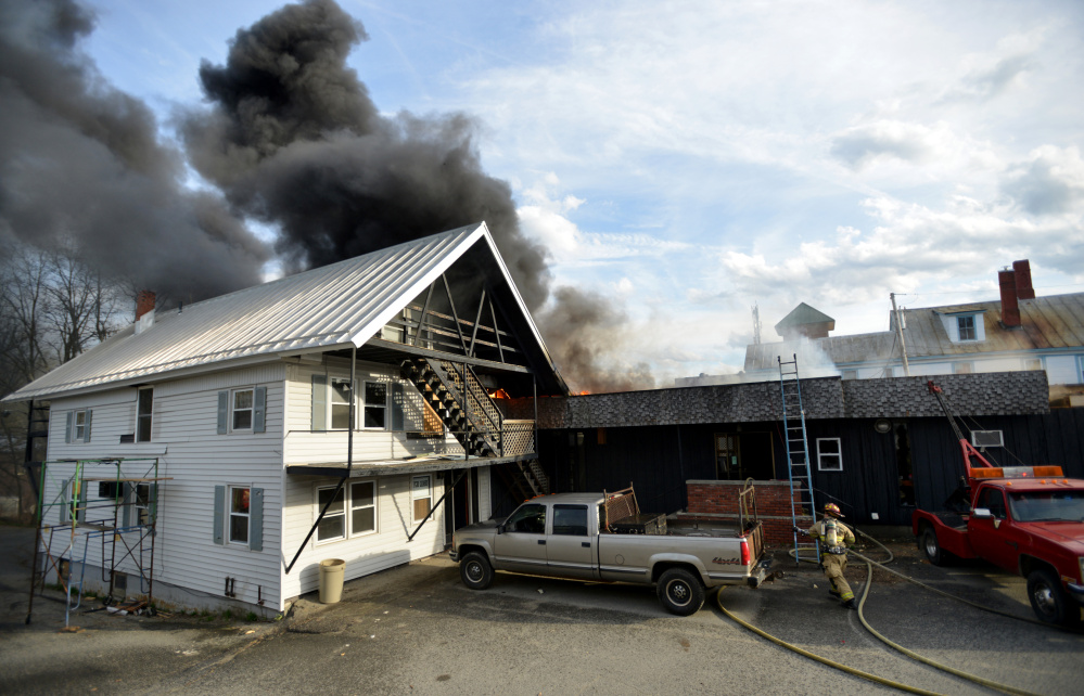 Firefighters battle a fire on College Avenue in Waterville on Saturday.