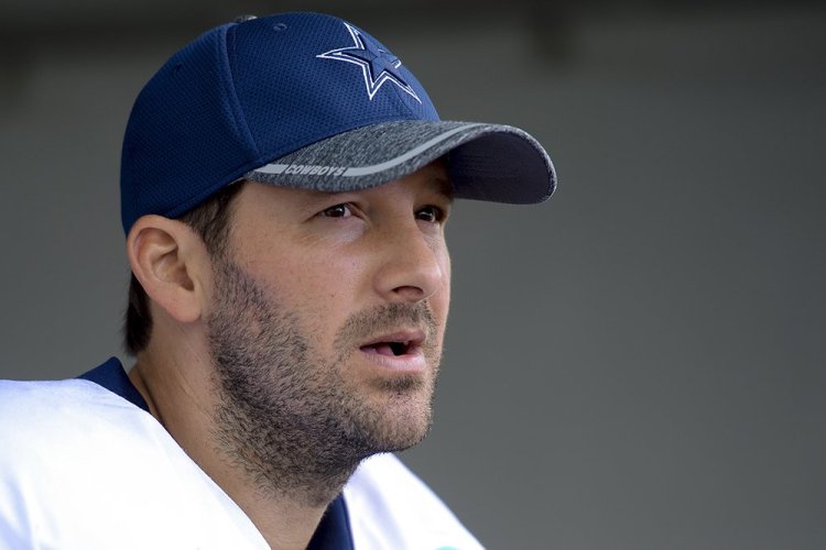 Tony Romo talks to reporters at the end of a team practice in Oxnard, Calif., last September. Romo, who turns 37 this month, was trying to recover from a series of back injuries that included two surgeries in less than a year.