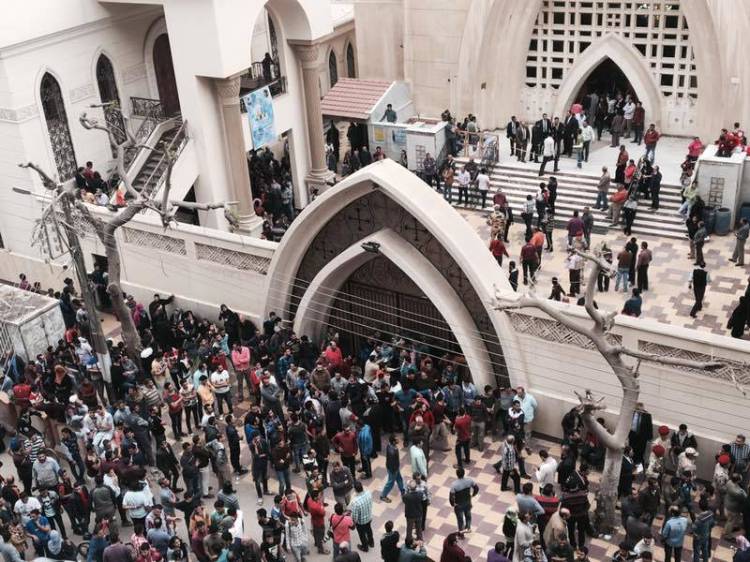 Relatives and onlookers gather outside a church after a bomb attack in the Nile Delta town of Tanta, Egypt, on Sunday. The attack took place on Palm Sunday, the start of the Holy Week leading up to Easter, when the church in the Nile Delta town of Tanta was packed with worshippers. 