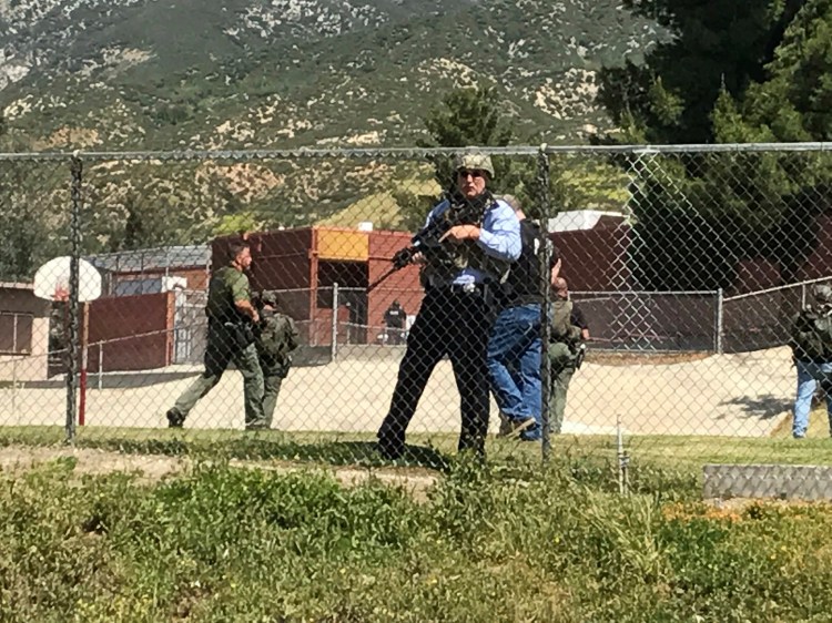 Emergency personnel respond to a shooting inside North Park School Elementary School on Monday in San Bernardino, Calif. 
