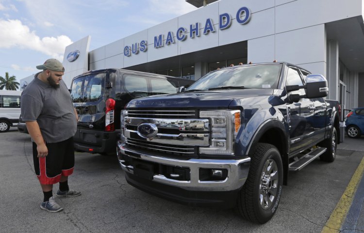 A potential customer looks at a 2017 Ford F-250 Lariat at a dealership in Hialeah, Fla., on Jan. 17.