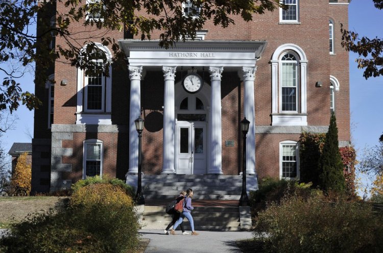 Students walk past Hathorn Hall on the Bates College campus in Lewiston. 