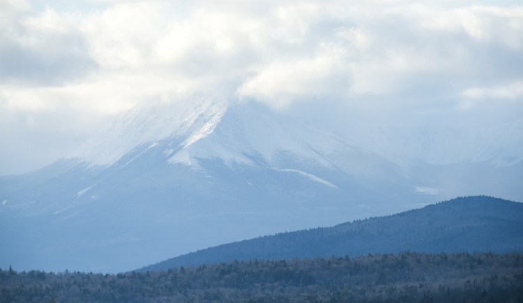 Snow and clouds obscure the peak of Mt. Katahdin in Baxter State Park, which borders the new Katahdin Woods and Waters National Monument. Three of the four members of Maine's congressional delegation want the monument designation to stand to avoid reopening a divisive debate in towns surrounding the property, but the governor wants it to be rescinded.