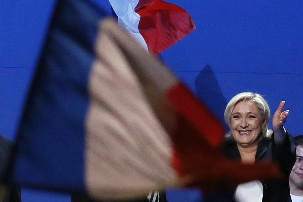 French far-right presidential candidate Marine Le Pen waves to supporters during her meeting, Monday May 1, 2017, in Villepinte, outside Paris. With just six days until a French presidential vote that could define Europe's future, far-right leader Marine Le Pen and centrist Emmanuel Macron are holding high-stakes rallies Monday. (AP Photo/Francois Mori)