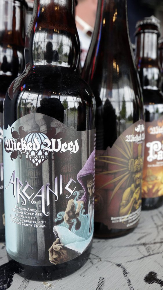 Brawley's Beverage in Charlotte, N.C., was selling off its Wicked Weed beer, above, on Thursday and ending sales of the brand to protest the purchase of the craft brewer by beer behemoth Anheuser-Busch Inbev, maker of Budweiser.