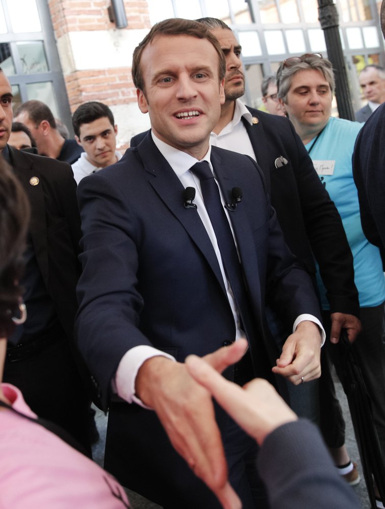 Independent presidential candidate Emmanuel Macron shakes hands with supporters during a campaign rally Thursday in southern France. His campaign said Friday that it was targeted in a "massive and coordinated" hacking attack that led to the leak of campaign emails and financial documents.