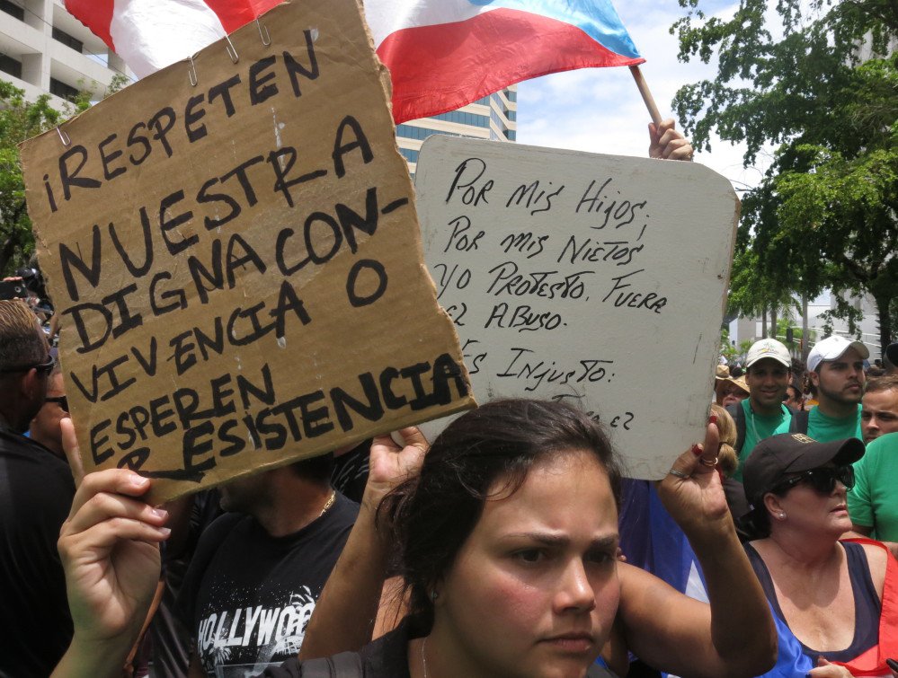 Demonstrators protest looming austerity measures amid an economic crisis and demand an audit on the island's debt to identify those responsible during the May Day march in San Juan, Puerto Rico, last week.