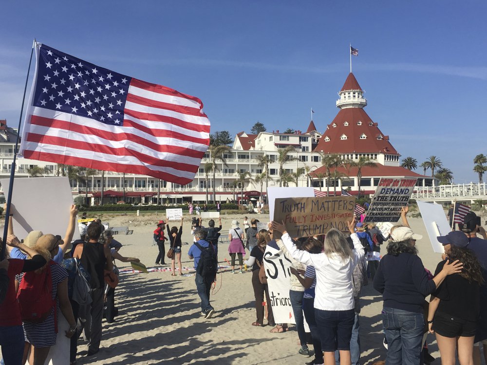 Protesters gather Thursday outside the Republican National Committee spring meeting in Coronado, Calif. About 300 protesters marched on the beach, chanting, "Hey, hey, ho, ho, Donald Trump has got to go!"