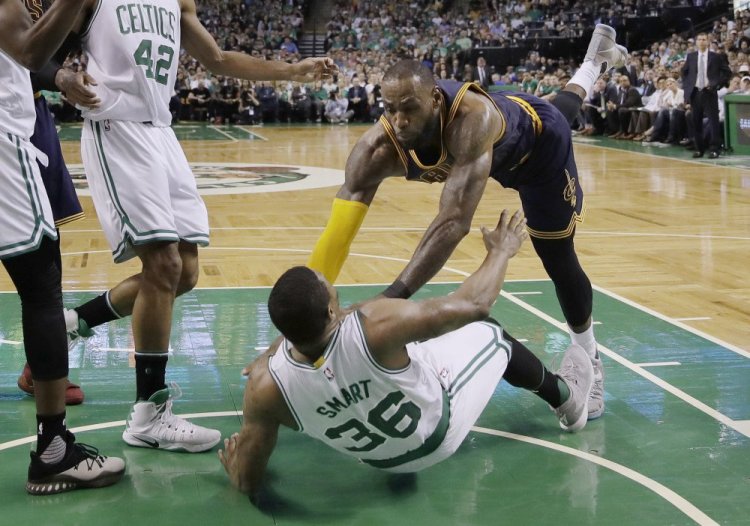 Cleveland's LeBron James falls to the floor with Boston's Marcus Smart in the second quarter of Game 1 of the Eastern Conference finals Wednesday night in Boston.
