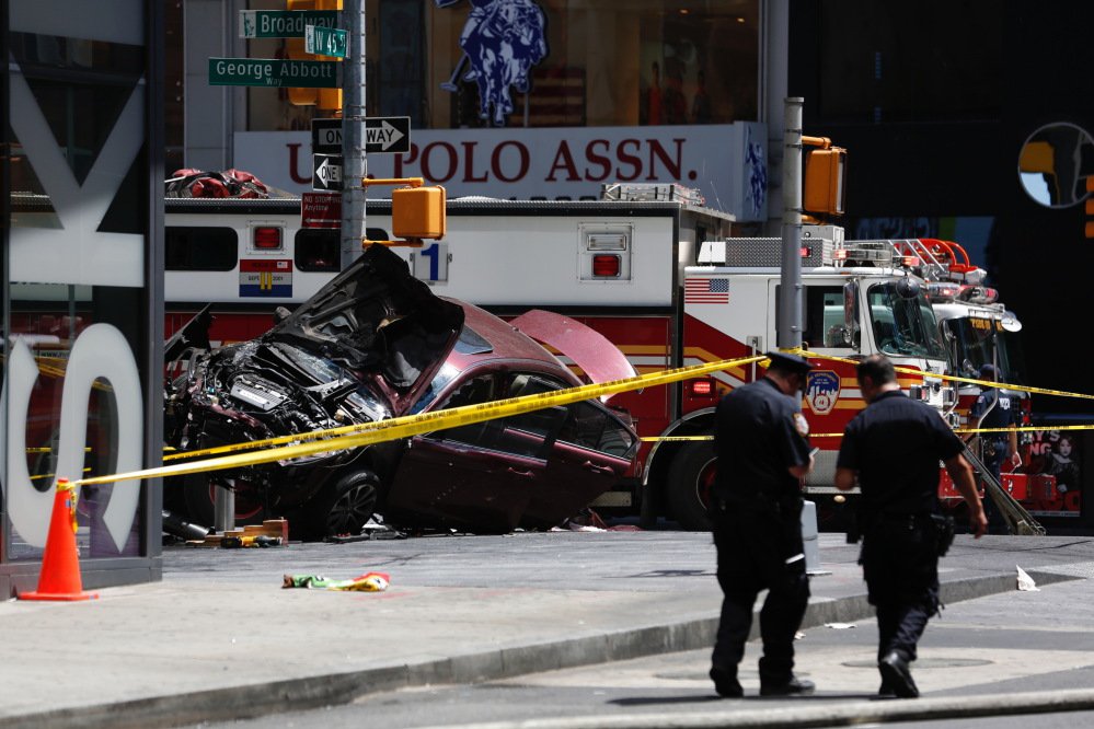A smashed car sits on the corner of Broadway and 45th Street in New York's Times Square after plowing through a crowd of pedestrians at lunchtime on Thursday.
