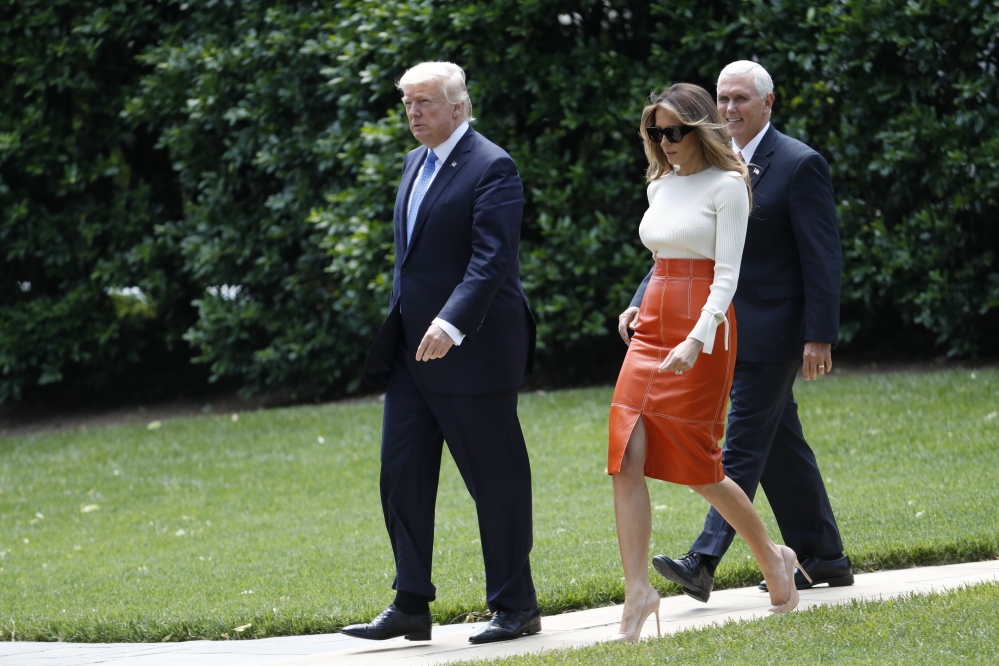 President Trump and first lady Melania Trump, escorted by Vice President Mike Pence, walk across the South Lawn of the White House on Friday before boarding Marine One for the short trip to Andrews Air Force Base, Md. Trump left for his first foreign trip, visiting Saudi Arabia, Israel and the Vatican, and attending summits in Brussels and Sicily.