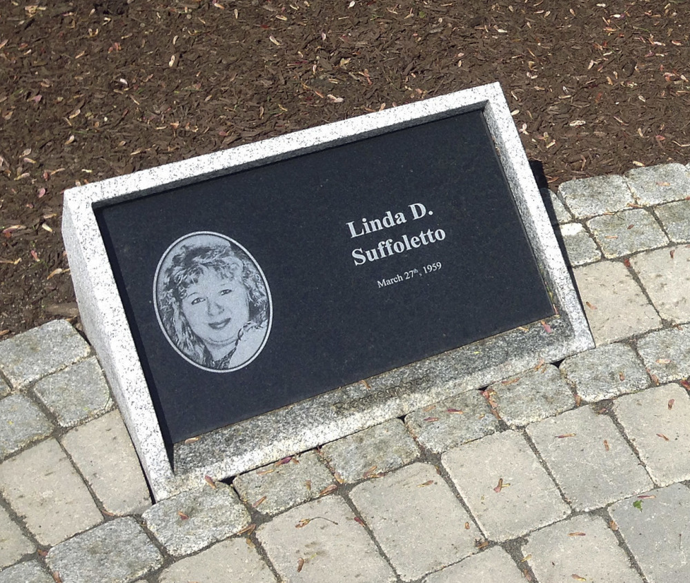 A plaque honors one of the victims of the nightclub fire in West Warwick, R.I.
