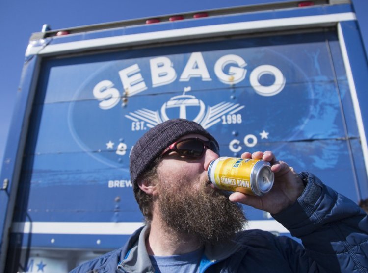 Tom Abercrombie, a brewmaster at Sebago Brewing Co., takes a celebratory sip of Simmer Down, its summer ale, at a groundbreaking event last month for the brewery's new headquarters in Gorham. After two years of double-digit growth, Sebago plans to double the size of its brewery and tasting room, hoping to draw fans off the beaten path.