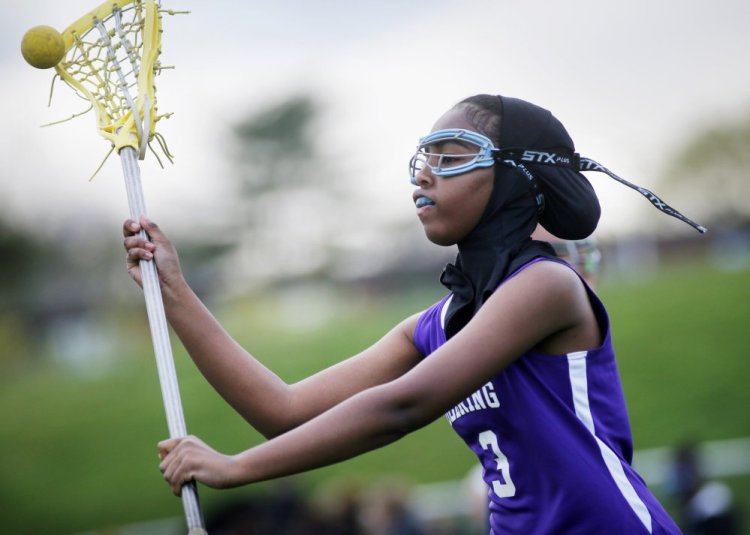 Fadumo Adan, a lacrosse player at Deering High, wears a sports hijab provided by the school. "It's just another part of the uniform," according to the Minnesota manufacturer.