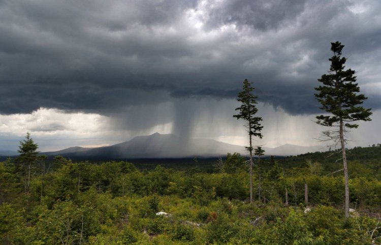 A rainstorm passes over Mount Katahdin in this 2015 view from land that is now the Katahdin Woods and Waters National Monument.