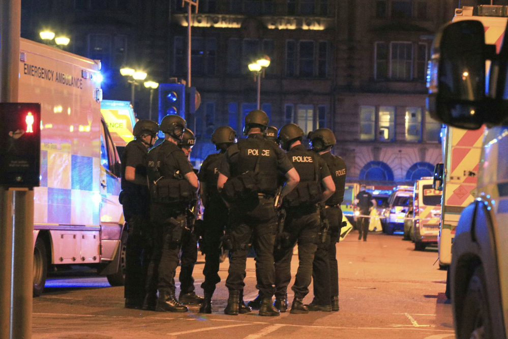 Armed police gather at Manchester Arena after reports of an explosion at the venue during an Ariana Grande concert.