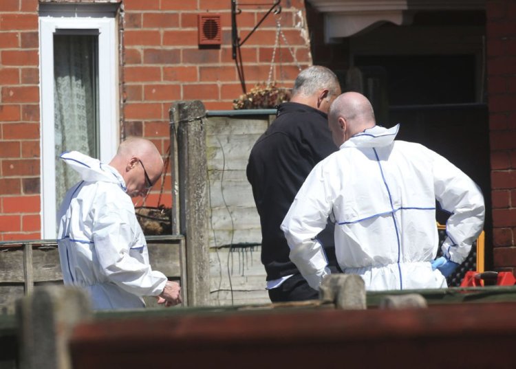 Police forensic investigators search the property of Salman Abedi on Tuesday in connection with the explosion that took place Monday at the Manchester Arena, in Greater Manchester, England.