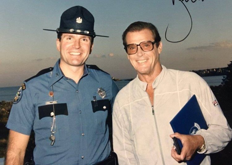 Randy Nichols and Roger Moore pose in 1989 after Moore was named an honorary state police captain.