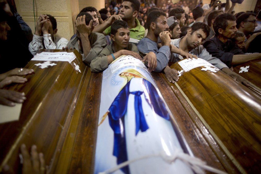 Relatives of Coptic Christians who were killed during a bus attack surround their coffins during their funeral service at Abu Garnous Cathedral in Minya, Egypt, on Friday.