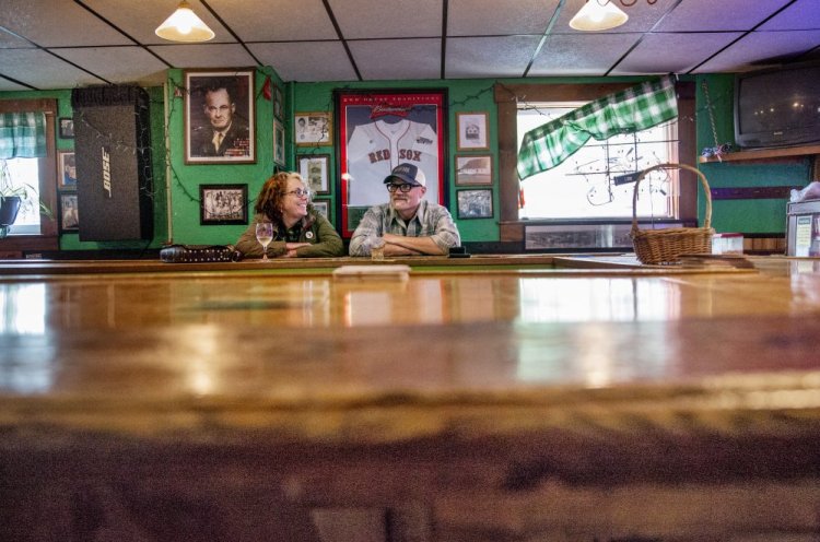 Matthew and Susan Robbins of South Portland have a drink at the bar on Friday. 
Staff photo by Derek Davis