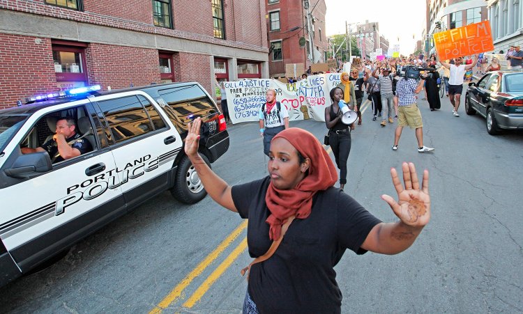 Shadiyo Hussain chants, “Hands up, don’t shoot!” with about 150 people as they march from Lincoln Park down Pearl Street to Commercial Street for a Black Lives Matter protest on July 15, 2016. The arrests made soon after began a court case that now appears to be over.