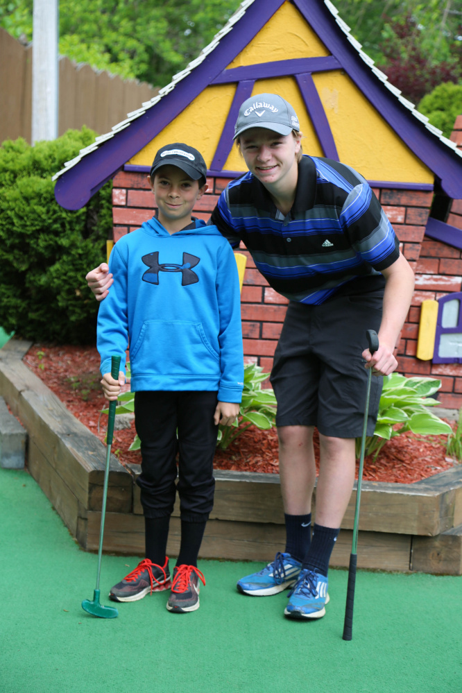 Colby Charette, left, and his "Little" Harrison Quimby, practice for the Putt 4 Cass fundraiser at Gifford's Famous Ice Cream & Mini Golf in Waterville.