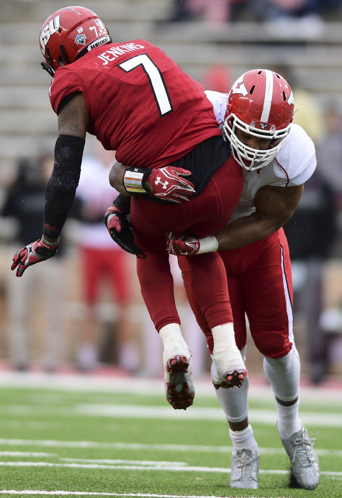 Youngstown State defensive end Derek Rivers, right, hits Jacksonville State quarterback Eli Jenkins during a game last season. Both players will get a shot in the NFL after the Patriots drafted Rivers and the Chargers signed Jenkins.